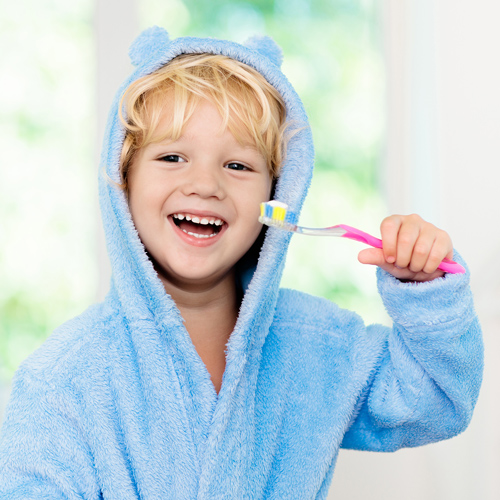Child brushing teeth after visiting Geelong dentist.
