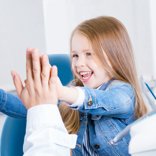 Young girl high fives Geelong family dentist.